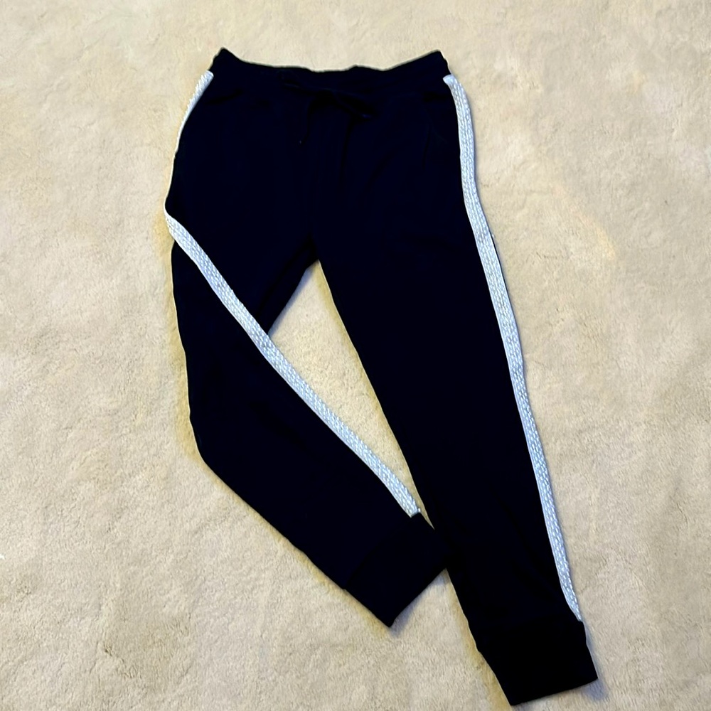 Black jogger with pearl edge accent along the outer seam